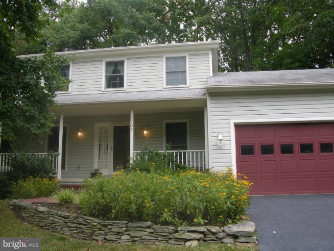 7709 Tower Woods Drive Springfield, VA 22153 - Photo 13 of 15 a view of a house with a yard