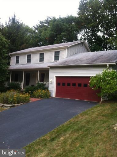 7709 Tower Woods Drive Springfield, VA 22153 - Photo 8 of 15 a front view of a house with a yard and garage