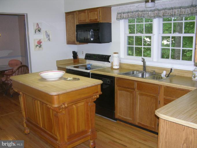 7709 Tower Woods Drive Springfield, VA 22153 - Photo 10 of 15 a kitchen with a stove a sink and a microwave