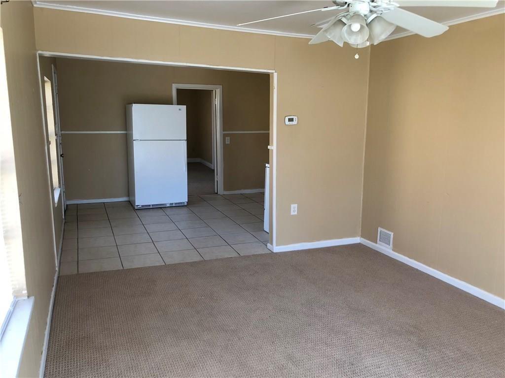 1602 South 9th Street Abilene, TX 79602 - Photo 4 of 9 an empty room with chandelier fan