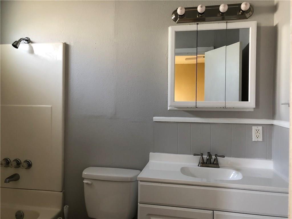 1602 South 9th Street Abilene, TX 79602 - Photo 7 of 9 a bathroom with a sink and a toilet