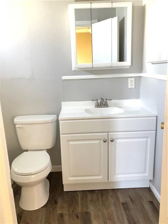 1602 South 9th Street Abilene, TX 79602 - Photo 9 of 9 a bathroom with a toilet sink and mirror