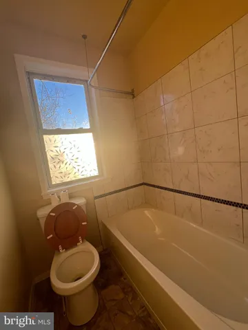 a view of a kitchen with a sink and a refrigerator