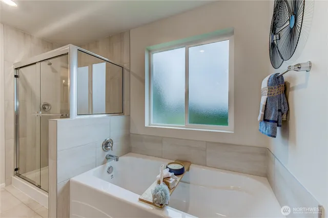a bathroom with a tub a sink and a window