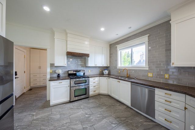 868 Braddock Lane Alpine, UT 84004 - Photo 15 of 64 Kitchen featuring white cabinetry with gold-toned hardware, dark stone countertops, and a gray subway tile backsplash