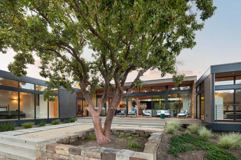 a front view of a building with trees