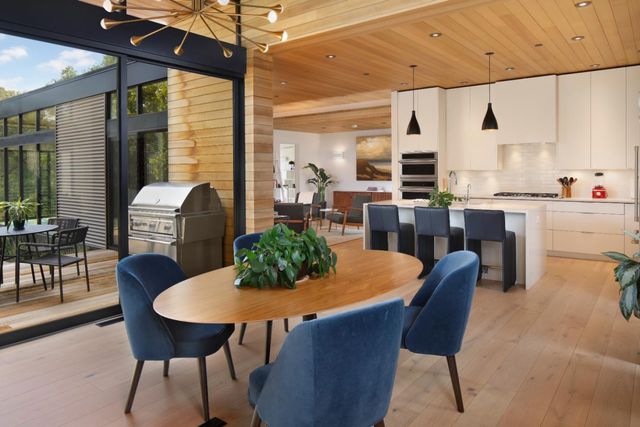 a dining room with furniture a window and wooden floor