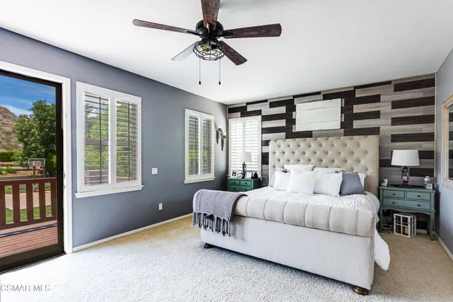 a bedroom with a bed couch and window