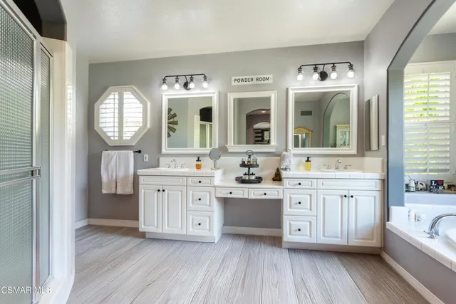 a spacious bathroom with a granite countertop sink and a mirror