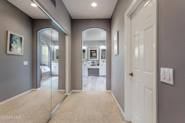 a view of a hallway view with wooden floor and living room