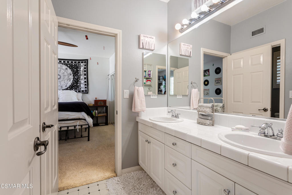 68 Twisted Oak Drive Simi Valley, CA 93065 - Photo 17 of 23 a en suite bathroom with a double vanity sink a mirror and shower