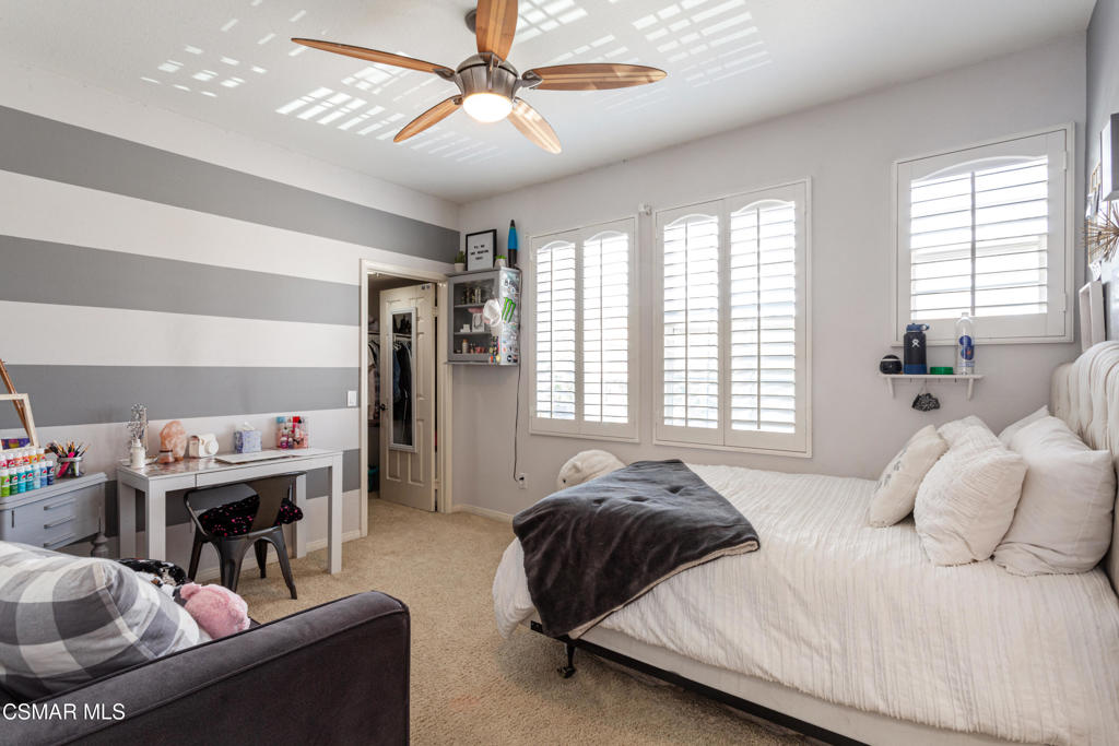 68 Twisted Oak Drive Simi Valley, CA 93065 - Photo 19 of 23 a bedroom with a bed and a chandelier