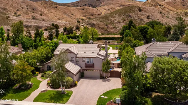 an aerial view of a house with a yard and garden