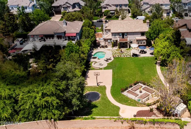 an aerial view of a house with garden space and street view