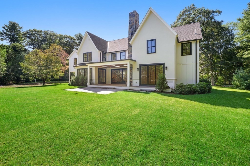 5 Radcliffe Road Weston, MA 02493 - Photo 2 of 41 a front view of a house with a yard and trees