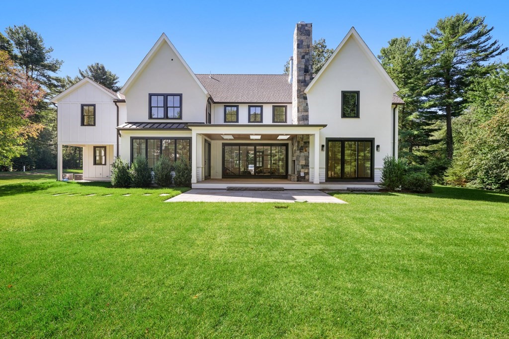5 Radcliffe Road Weston, MA 02493 - Photo 3 of 41 a front view of a house with a yard and garage