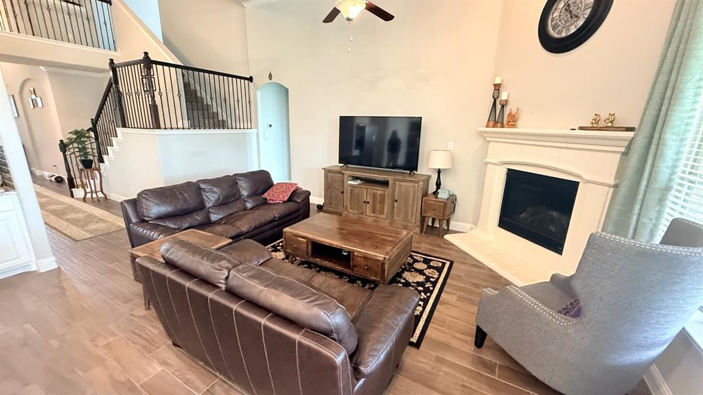 337 Prairie Ridge Lane Lewisville, TX 75056 - Photo 11 of 28 a living room with furniture a flat screen tv and a fireplace