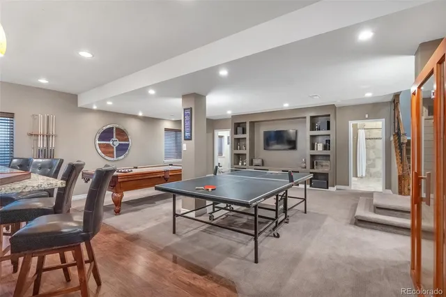a living room with furniture a table and a large window