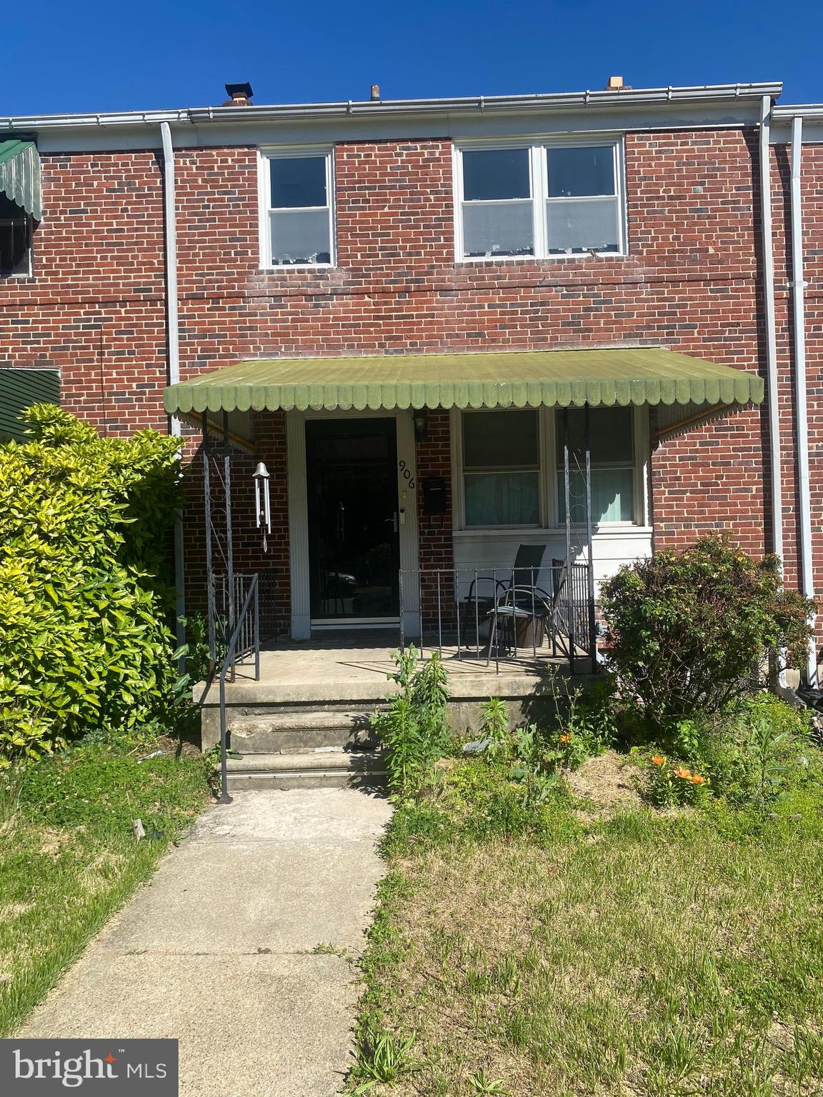 906 Masefield Road Baltimore, MD 21207 - Photo 18 of 22 a view of brick building with large windows and a small yard