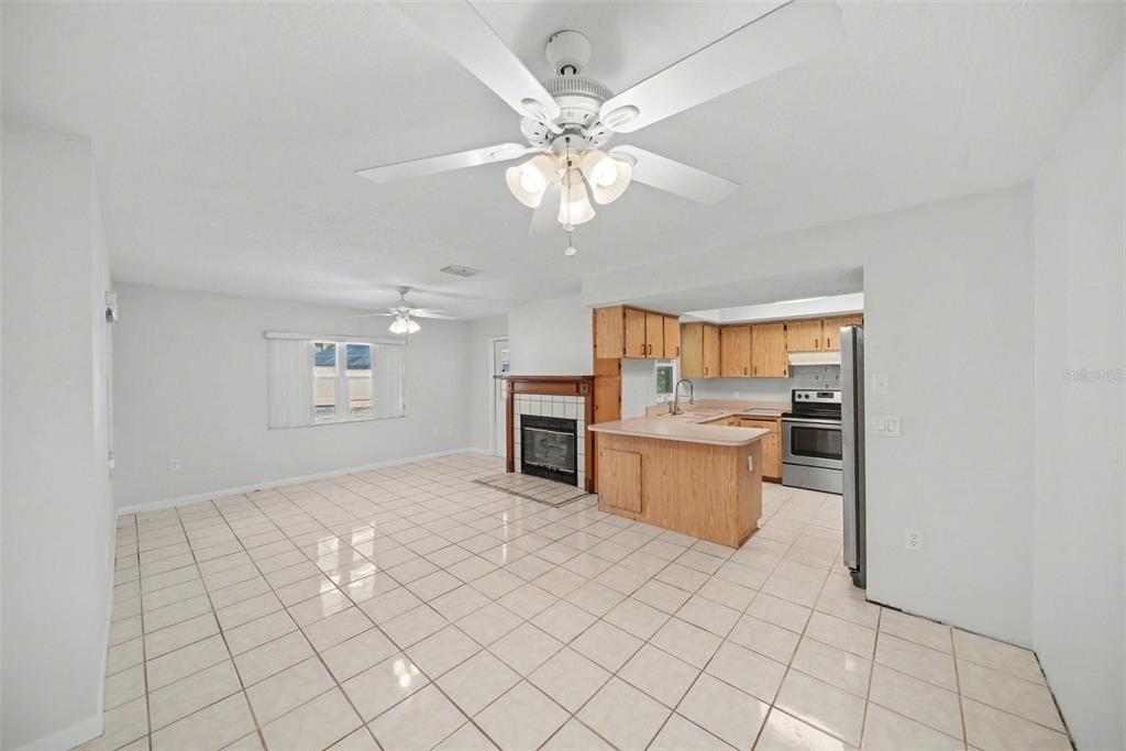 113 Ruskin Avenue Spring Hill, FL 34606 - Photo 11 of 32 a view of a kitchen with furniture cabinets and window