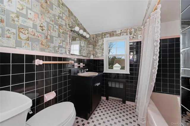 a bathroom with a toilet a sink and a shower