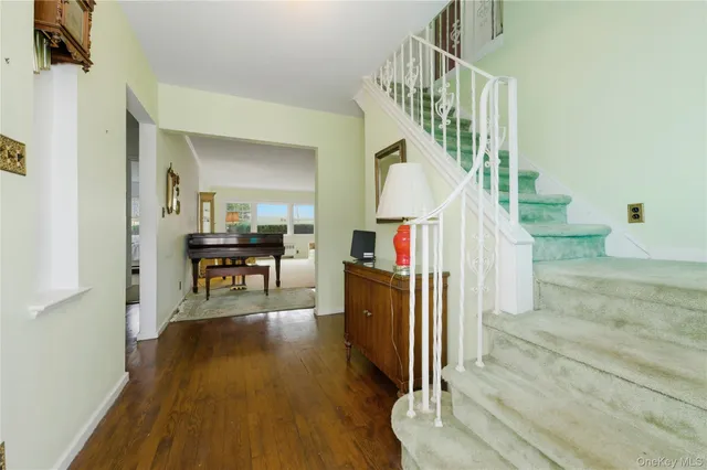 a view of entryway and hall with wooden floor