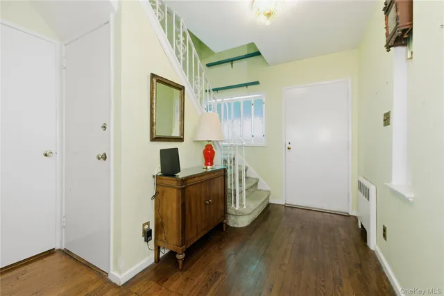 a view of hallway with wooden floor