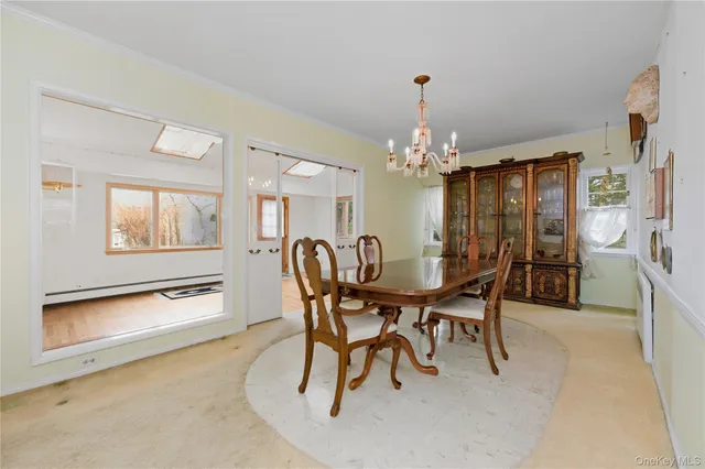 a view of a dining room with furniture and chandelier