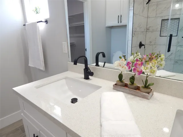 a bathroom with a sink a vanity and a mirror