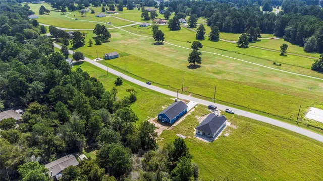 an aerial view of a house with a swimming pool