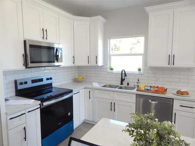 a kitchen with a sink stove and cabinets