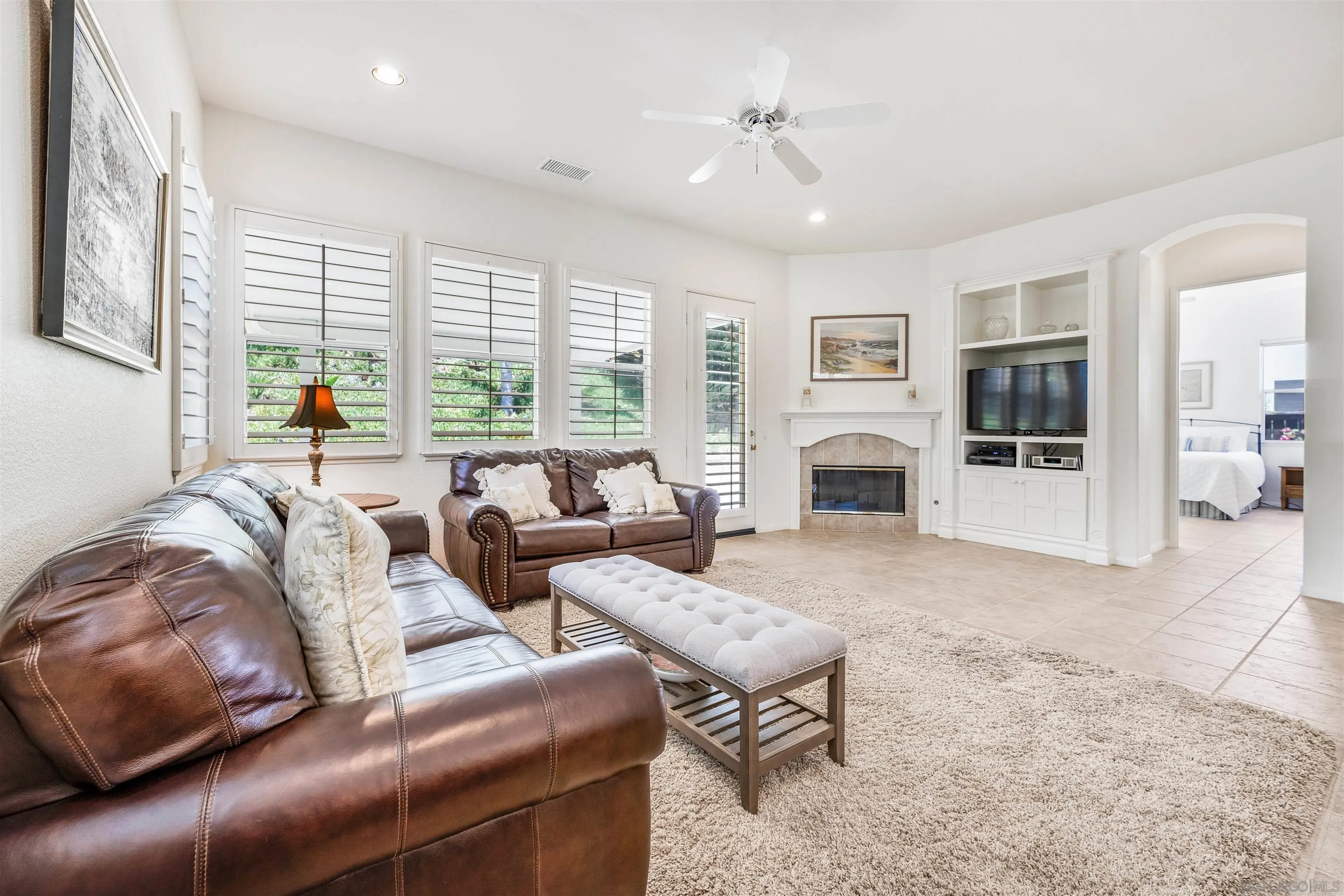 3012 Avenida Ciruela Carlsbad, CA 92009 - Photo 13 of 40 a living room with furniture window and a fireplace