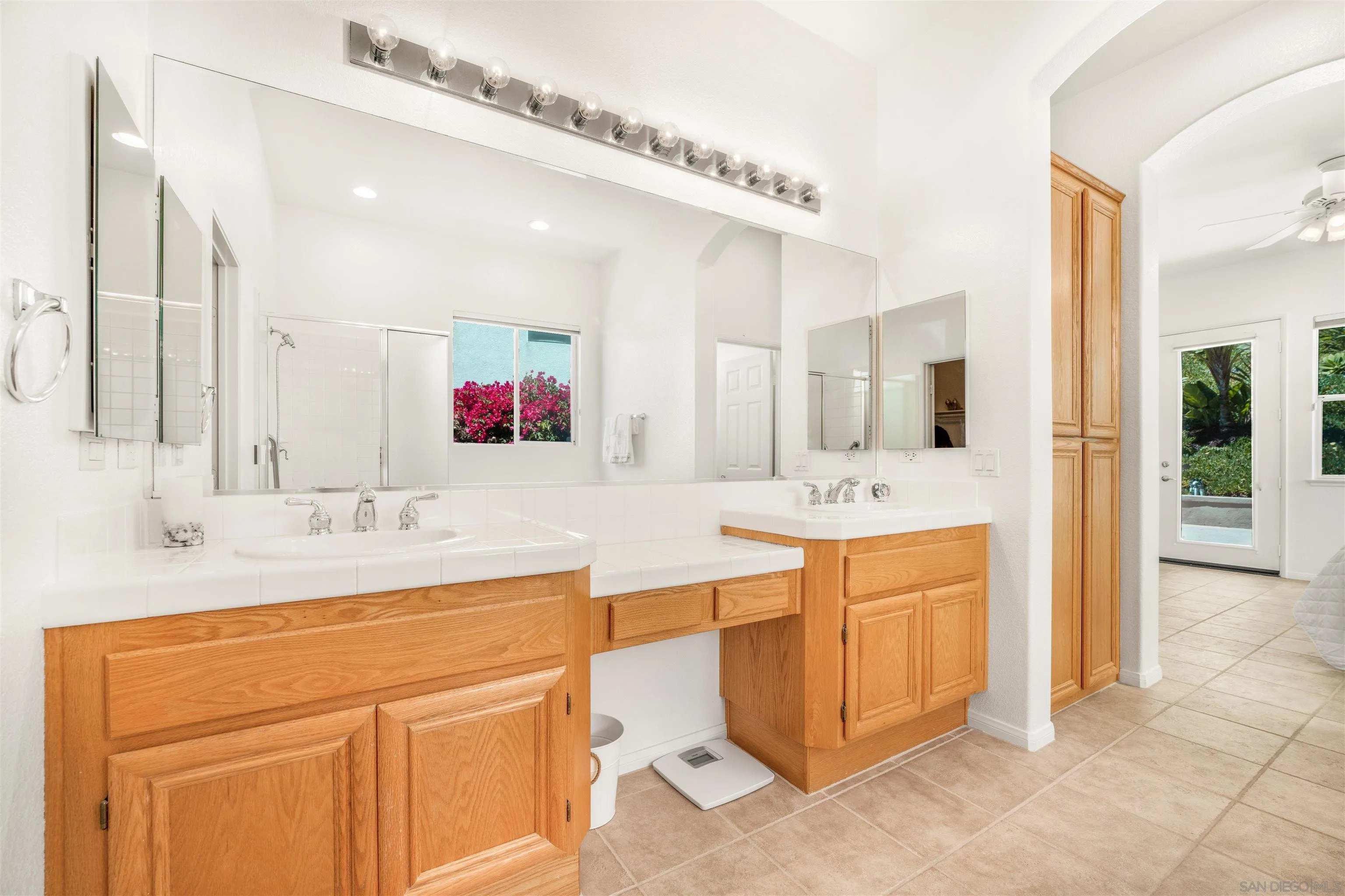 3012 Avenida Ciruela Carlsbad, CA 92009 - Photo 19 of 40 a bathroom with a sink vanity tub and a mirror