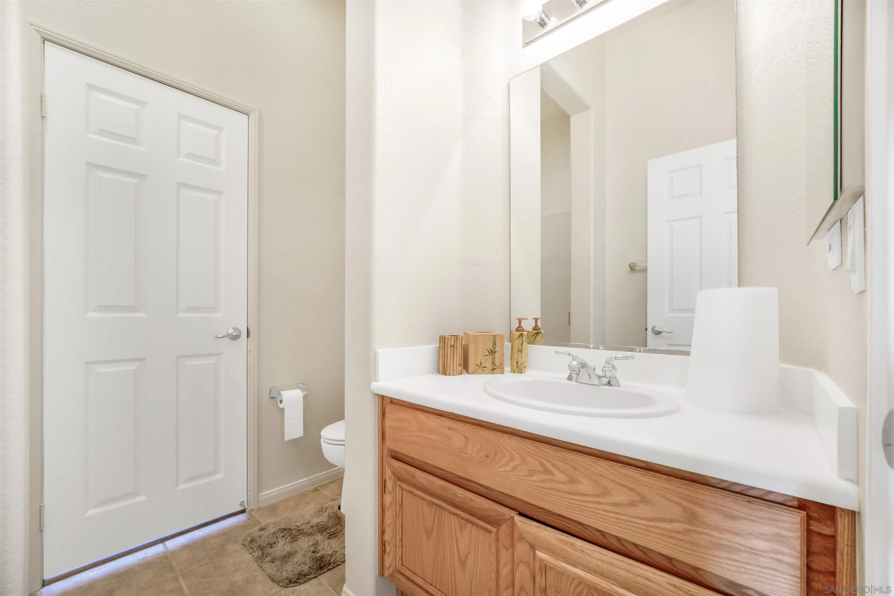 3012 Avenida Ciruela Carlsbad, CA 92009 - Photo 21 of 40 a bathroom with a sink and a mirror