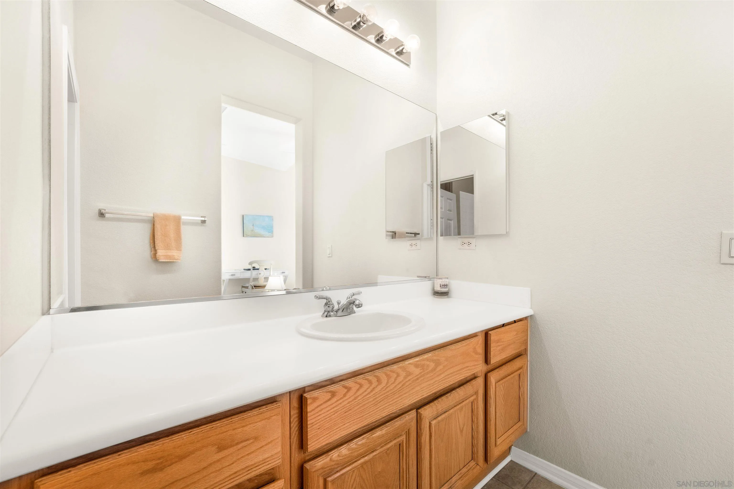 3012 Avenida Ciruela Carlsbad, CA 92009 - Photo 27 of 40 a bathroom with a sink and a mirror