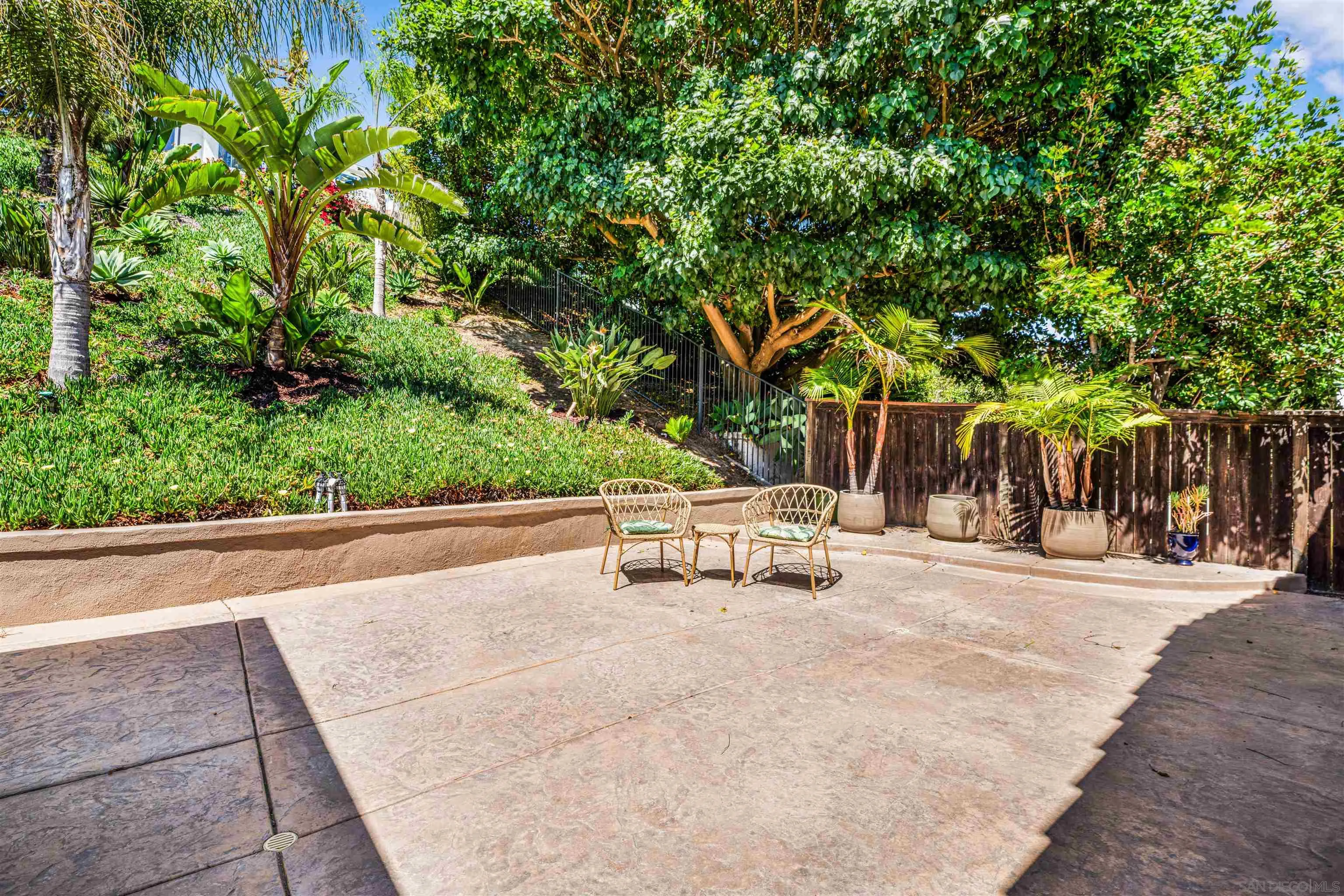 3012 Avenida Ciruela Carlsbad, CA 92009 - Photo 30 of 40 a view of a street with a bench and trees beside of it