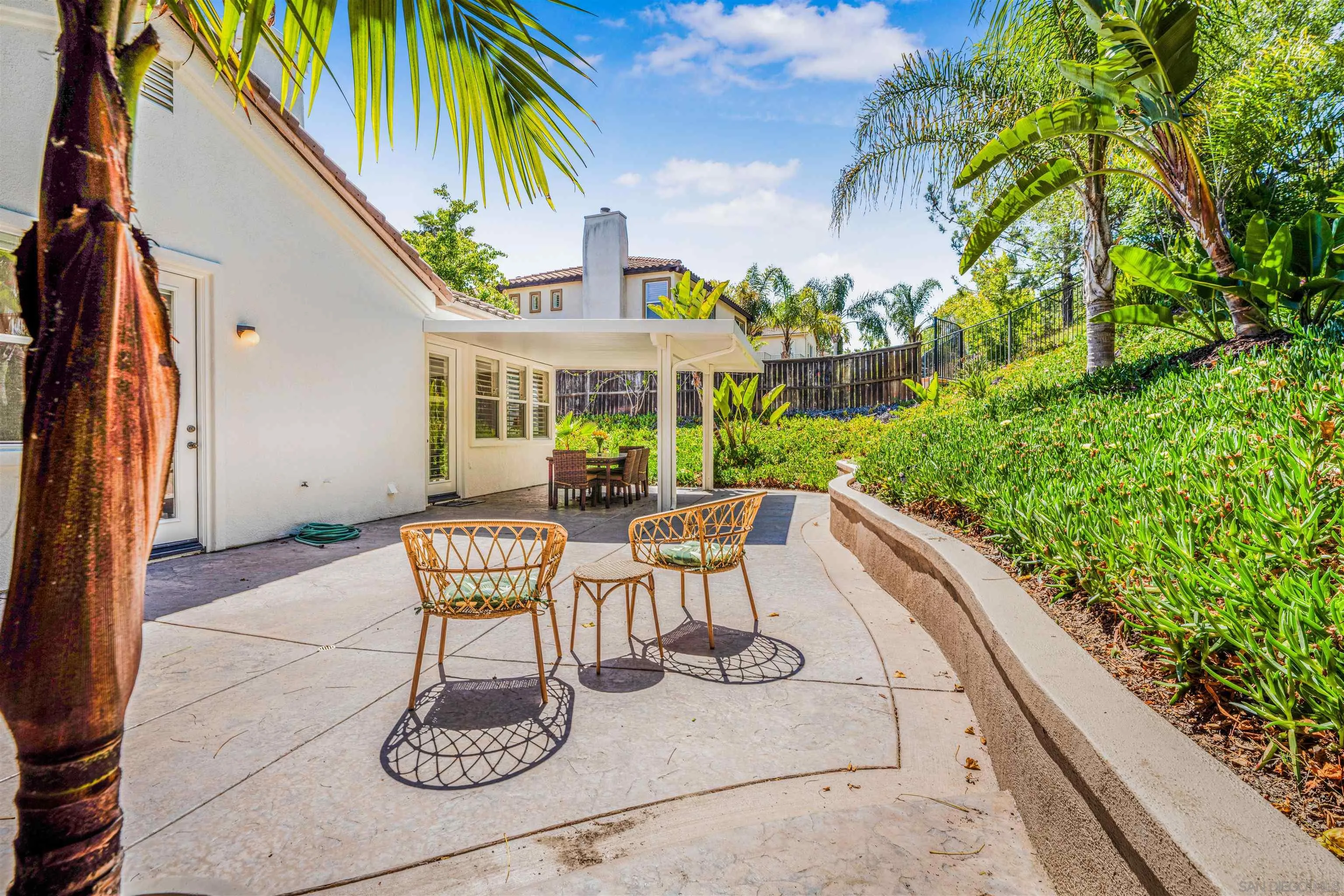 3012 Avenida Ciruela Carlsbad, CA 92009 - Photo 32 of 40 a view of a patio with couches table and chairs and potted plants