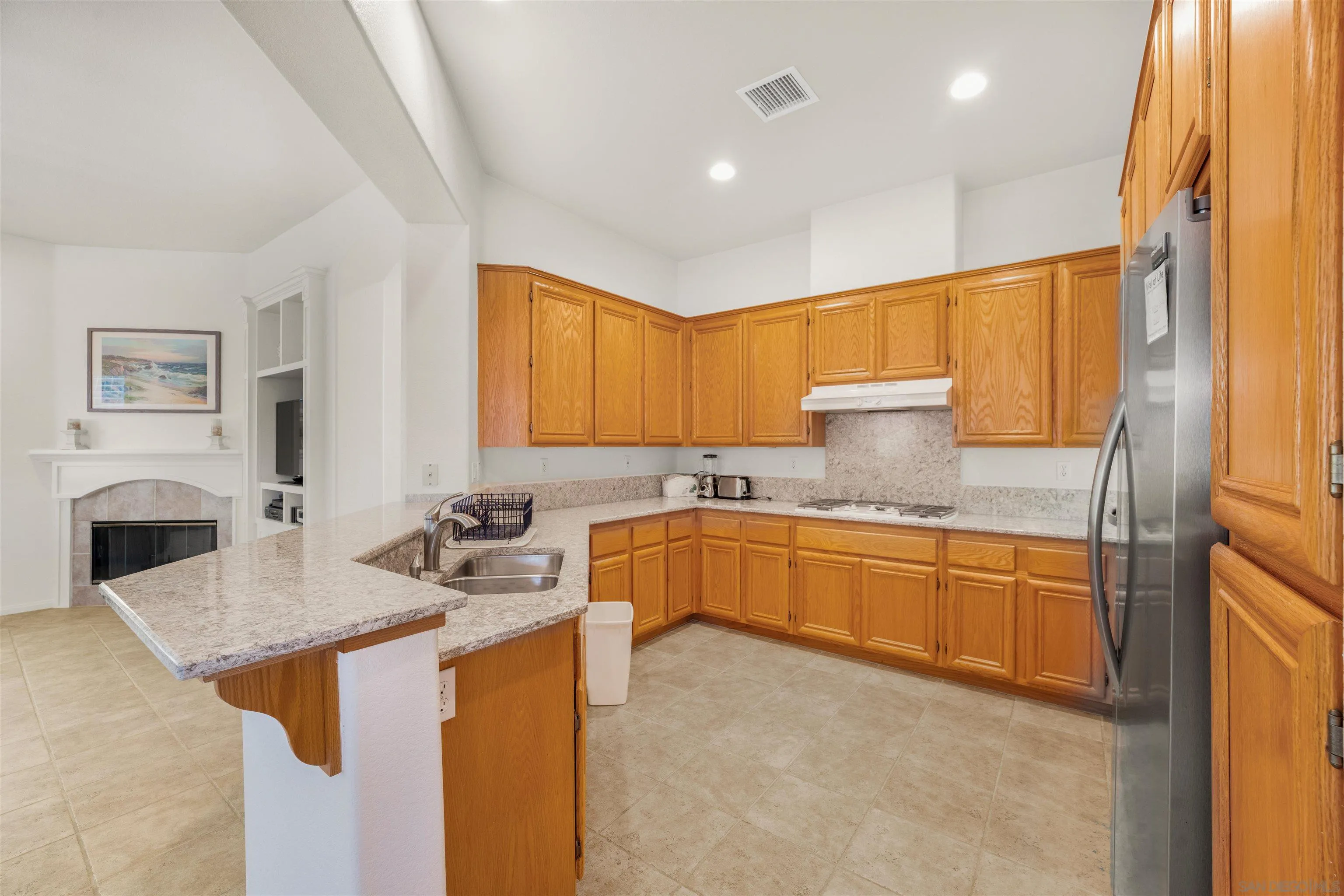 3012 Avenida Ciruela Carlsbad, CA 92009 - Photo 10 of 40 a kitchen with granite countertop a sink stove and refrigerator