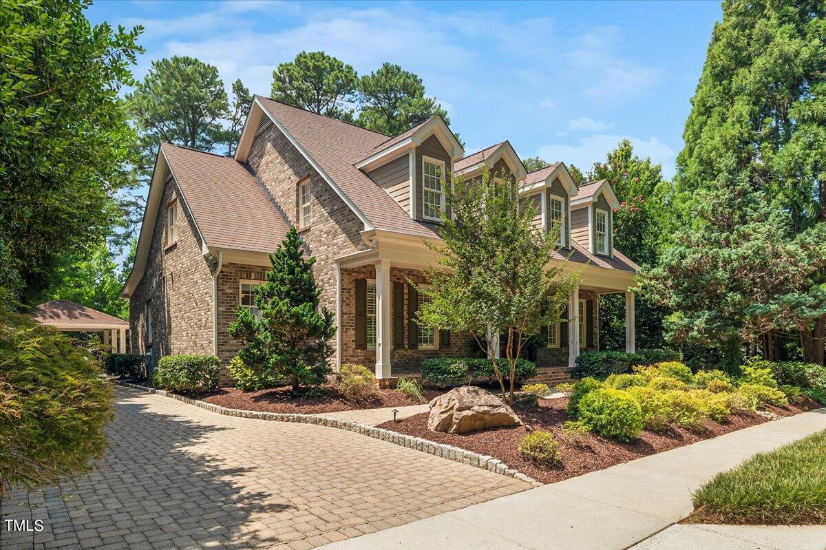 4433 Harbourgate Drive Raleigh, NC 27612 - Photo 1 of 3 a view of a white house with a yard and potted plants