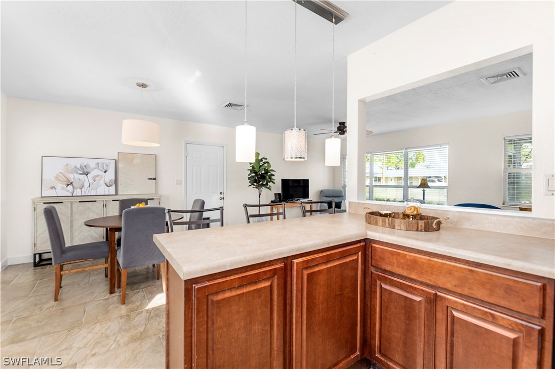 1448 Byron Road Fort Myers, FL 33919 - Photo 14 of 30 a kitchen with a sink and chairs