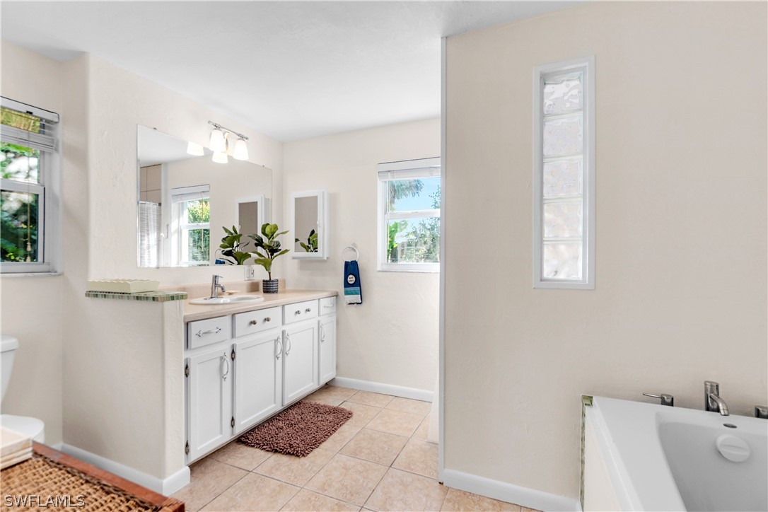 1448 Byron Road Fort Myers, FL 33919 - Photo 16 of 30 a spacious bathroom with a double vanity sink mirror and bathtub