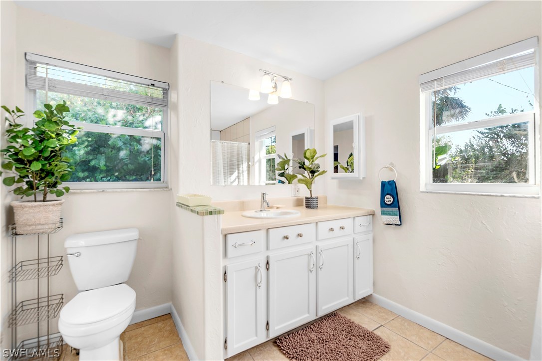 1448 Byron Road Fort Myers, FL 33919 - Photo 17 of 30 a bathroom with a toilet sink and mirror