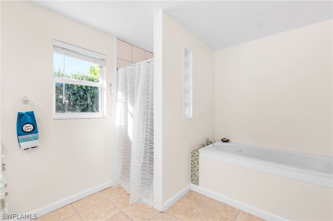 1448 Byron Road Fort Myers, FL 33919 - Photo 18 of 30 a bathroom with a bathtub and shower