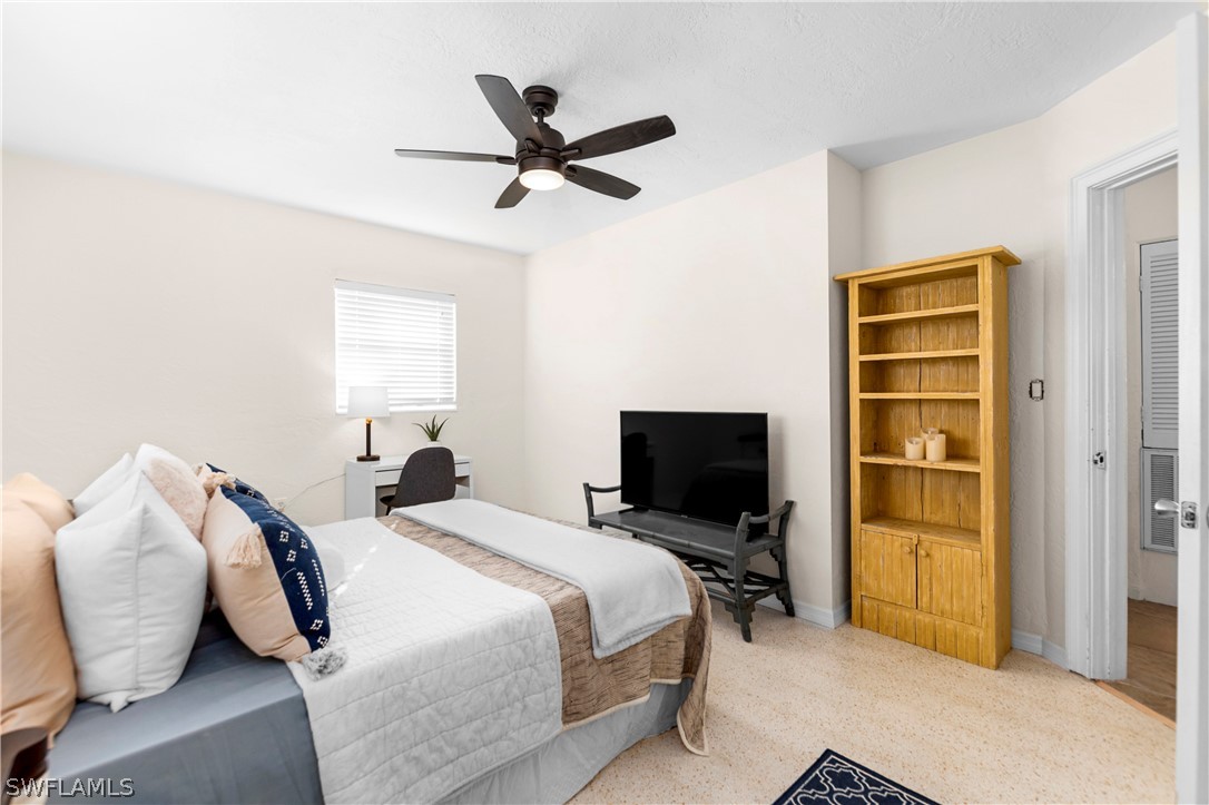 1448 Byron Road Fort Myers, FL 33919 - Photo 20 of 30 a bedroom with a bed and a chandelier