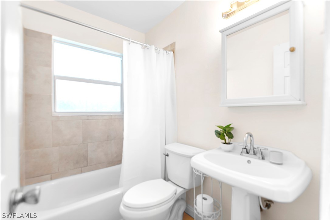 1448 Byron Road Fort Myers, FL 33919 - Photo 21 of 30 a bathroom with a sink a toilet and shower