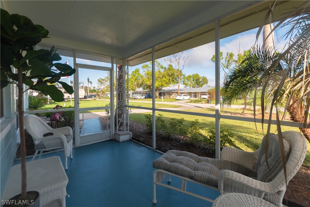 1448 Byron Road Fort Myers, FL 33919 - Photo 4 of 30 a living room with furniture and a floor to ceiling window