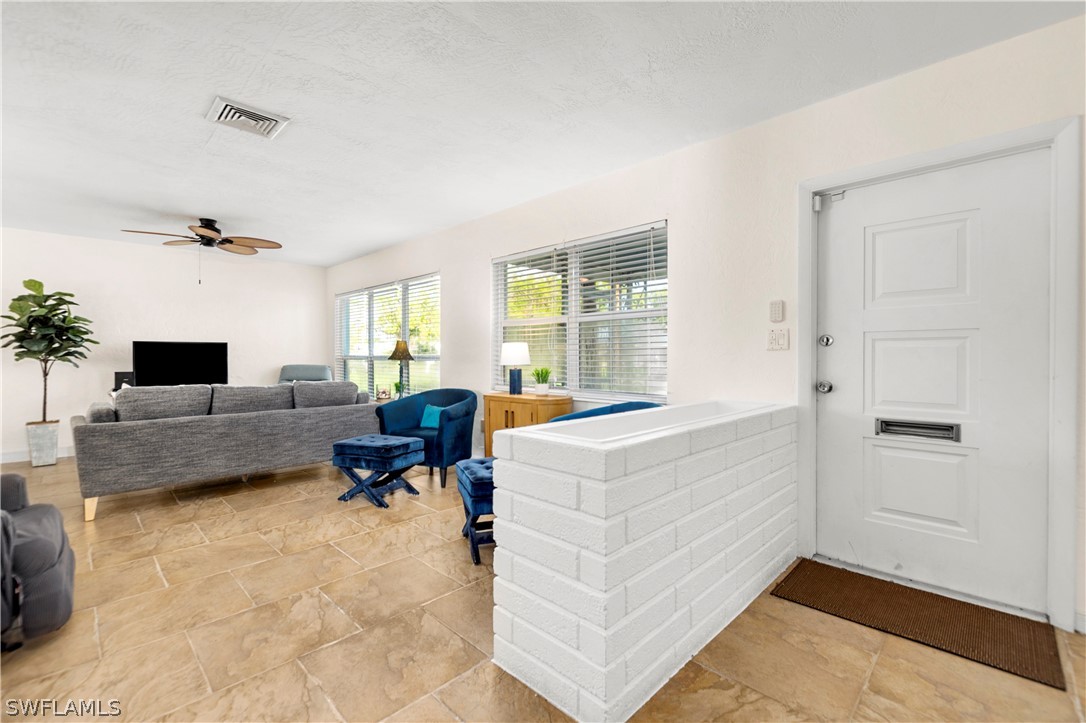 1448 Byron Road Fort Myers, FL 33919 - Photo 5 of 30 a living room with furniture and a flat screen tv