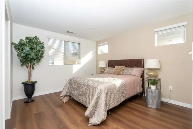 a bedroom with bed and a potted plant