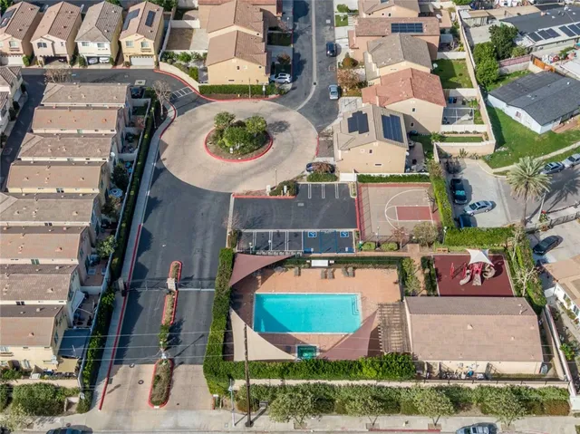 an aerial view of residential houses with outdoor space and swimming pool