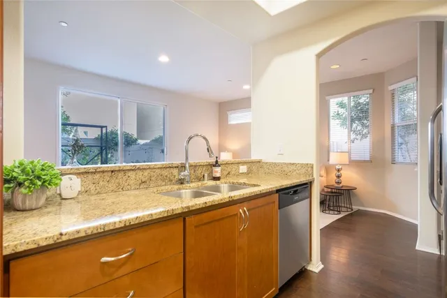 a view of a kitchen with a sink and wooden floor